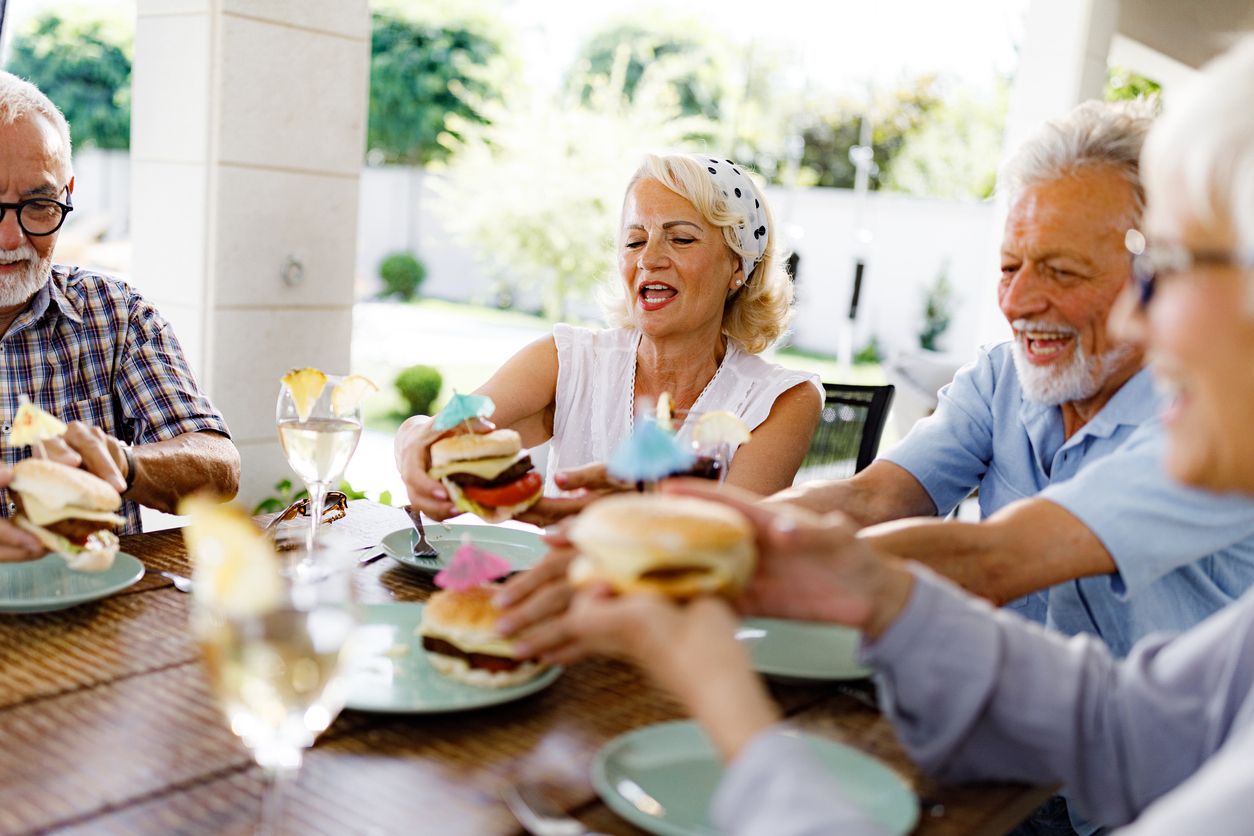 Fall recipes - A group of seniors sitting together and enjoying eating Sloppy Joes.