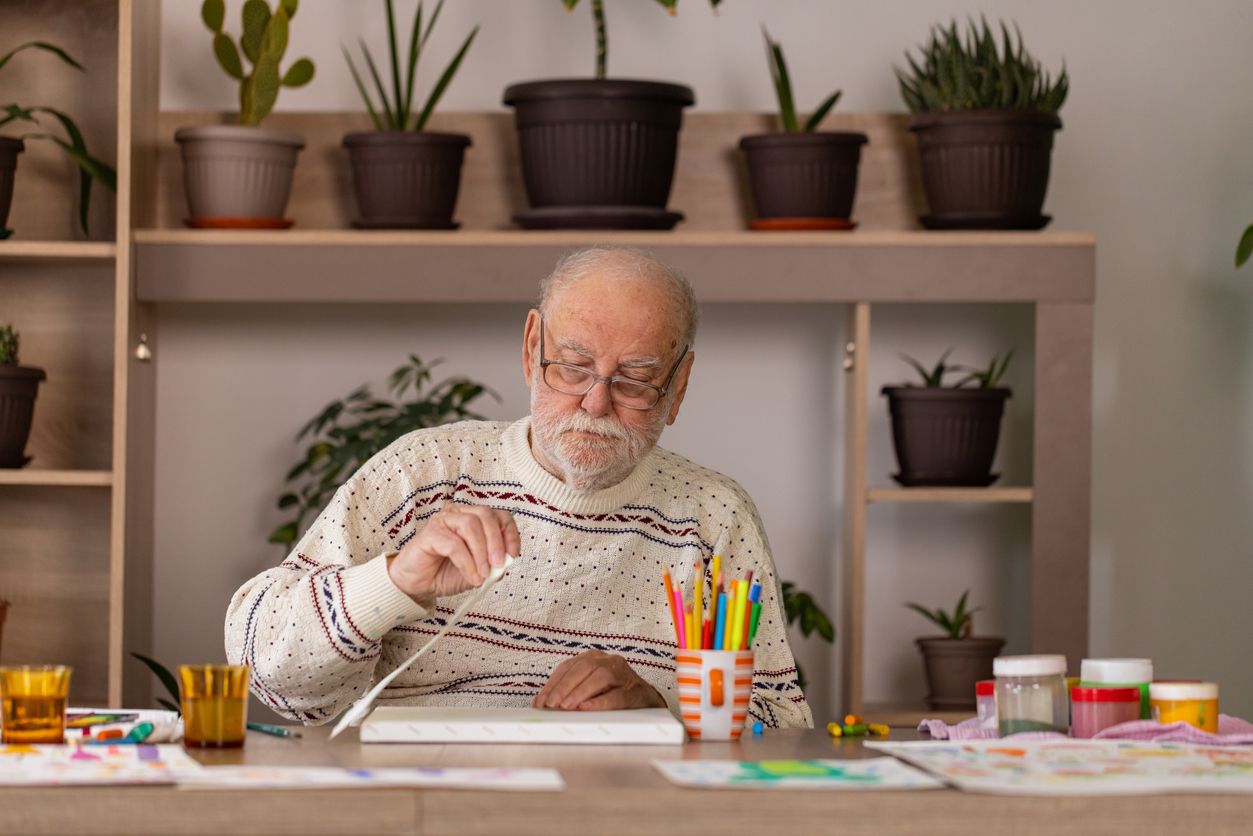 Dementia artist painting a picture in the studio